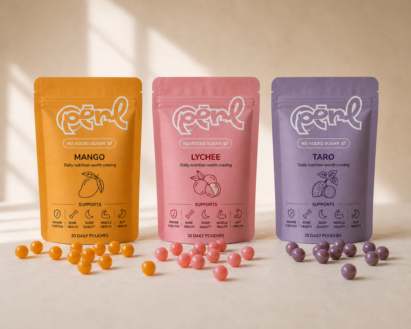 Three Vitaperl pouches in mango, lychee, and taro flavours with boba pearls scattered in front